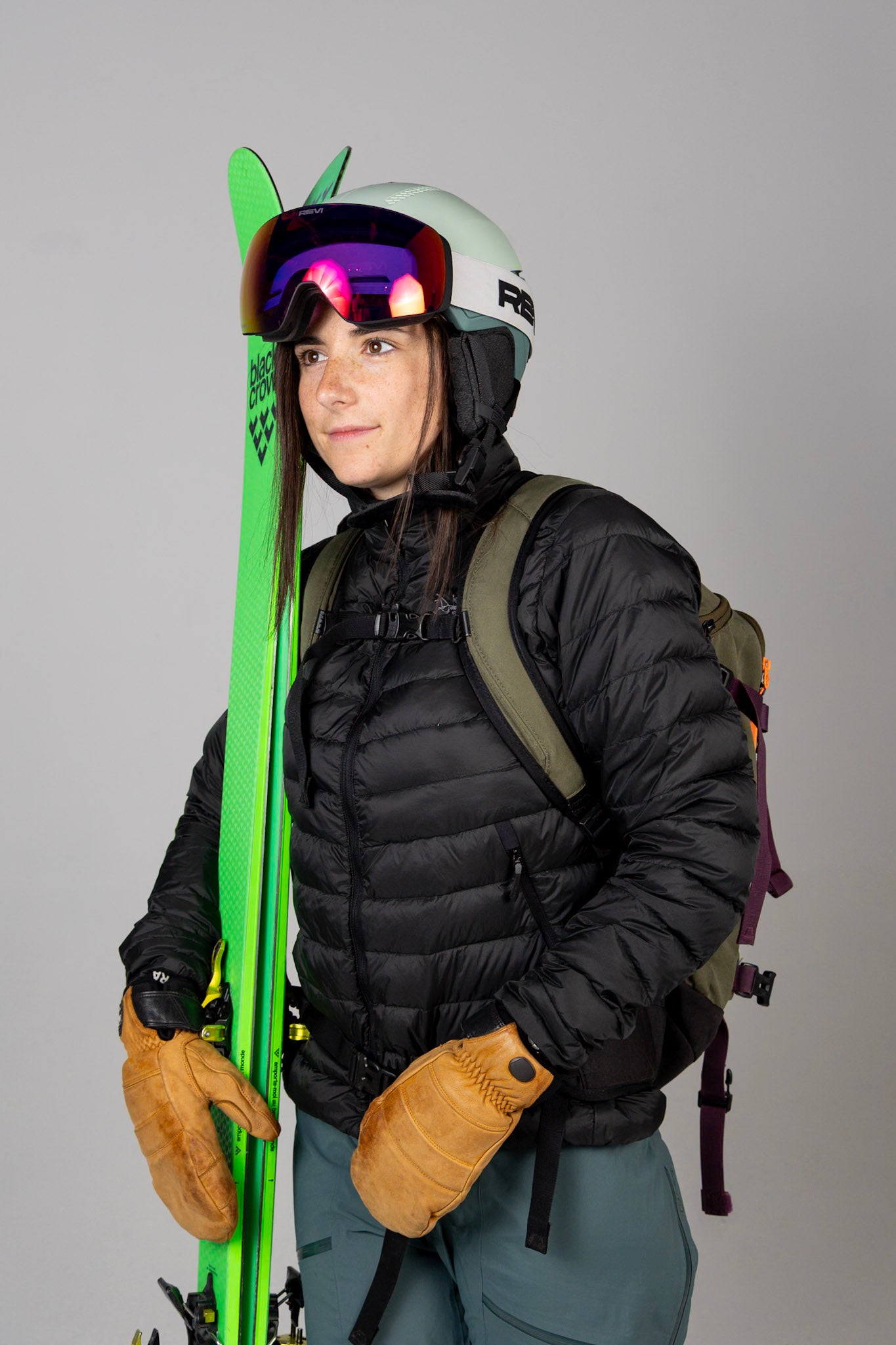 Revi Founder Lizzie wearing The Challenger Ski Snowboard Helmet in with skis 